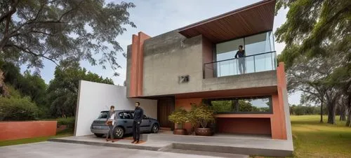 In the center of a serene meadow, a cozy den filled with natural light comes into view. It's a minimalist residential house, with white concrete elements, clad in polished sloping exteriors, adorned w