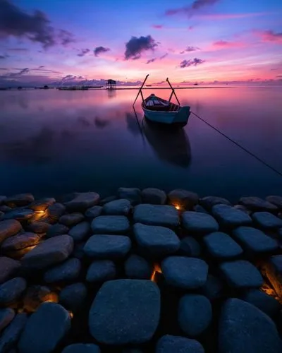 indonesia,background with stones,sanur,calmness,boat landscape,old wooden boat at sunrise