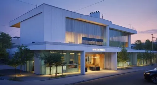 As the camera zooms in on the exterior façade, a man in a crisp orange hat sits at the edge of a rickety glass podium, his eyes locked as the viewer gazes out at the bustling intersection. The exterio