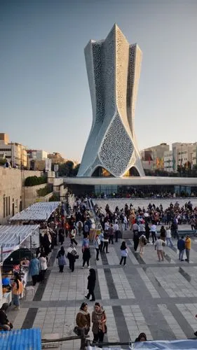 A stunning parametric modern tower  inspired by flying and wings, featuring a facade of white stone and composite materials, accented by reflective gray windows. The tower's design is inspired by intr