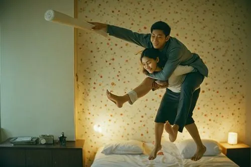 a woman is carrying a man on her back,a man is jumping on the bed while the woman has her leg wrapped around him,pillow fight,oldboy,matchpoint,leehom,gondry,ghajini,Photography,Documentary Photograph